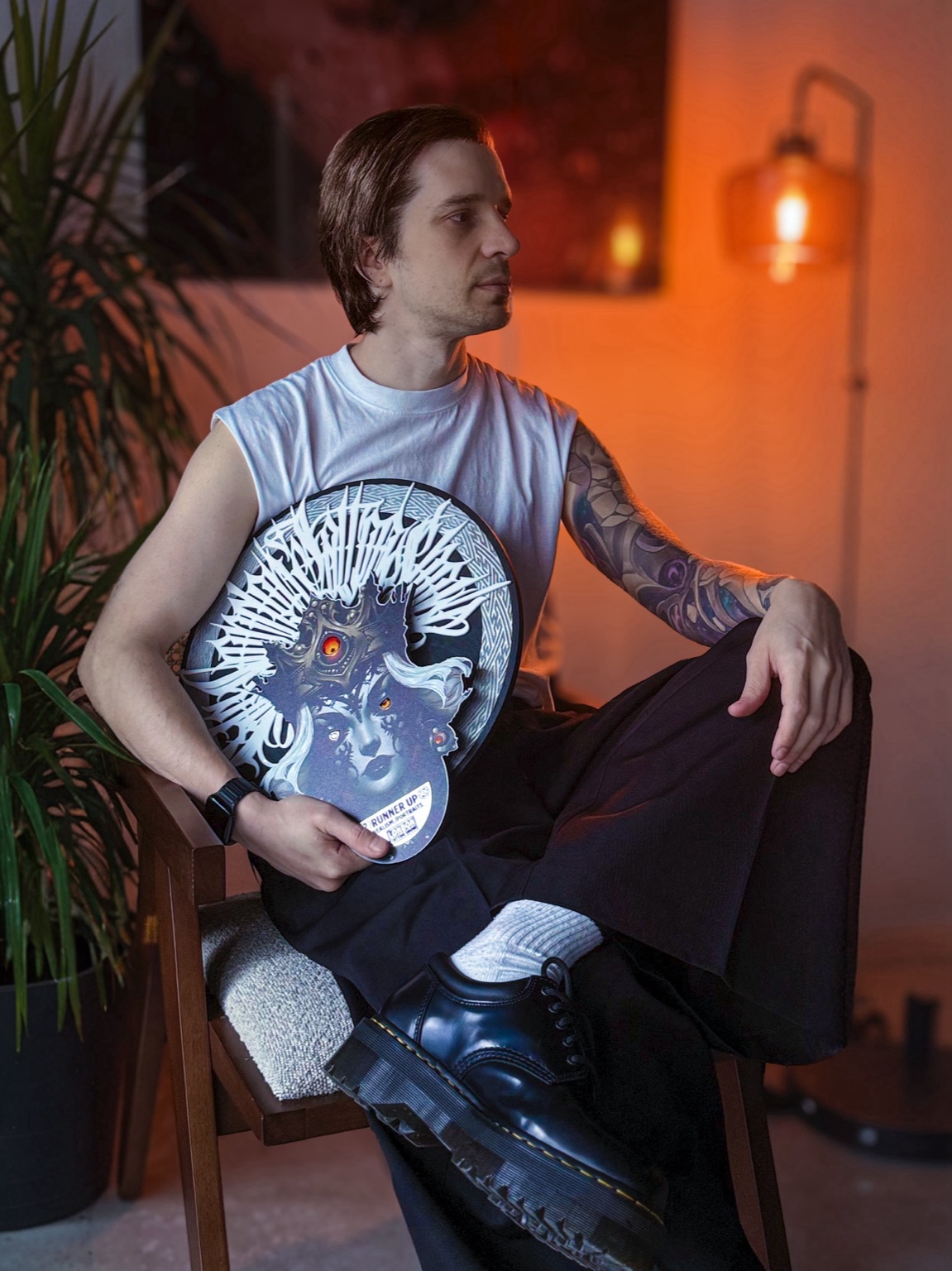 Artist seated with award