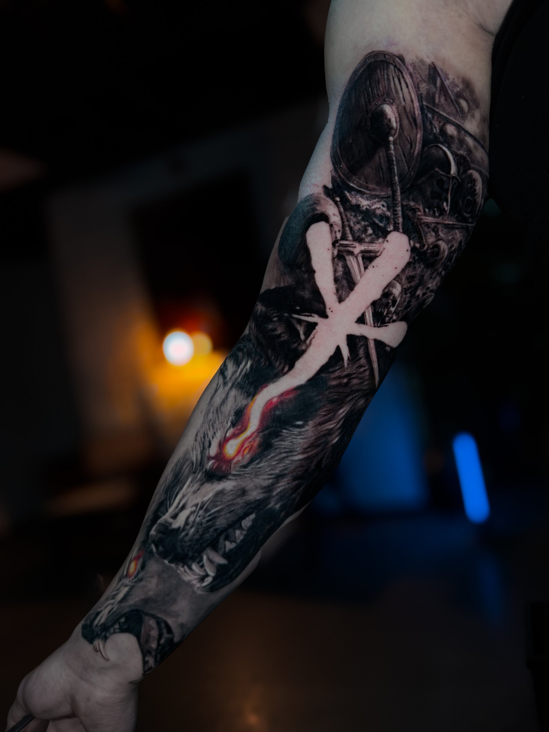 Large-scale black and grey realism arm tattoo with abstract elements by Vladimir Vishar