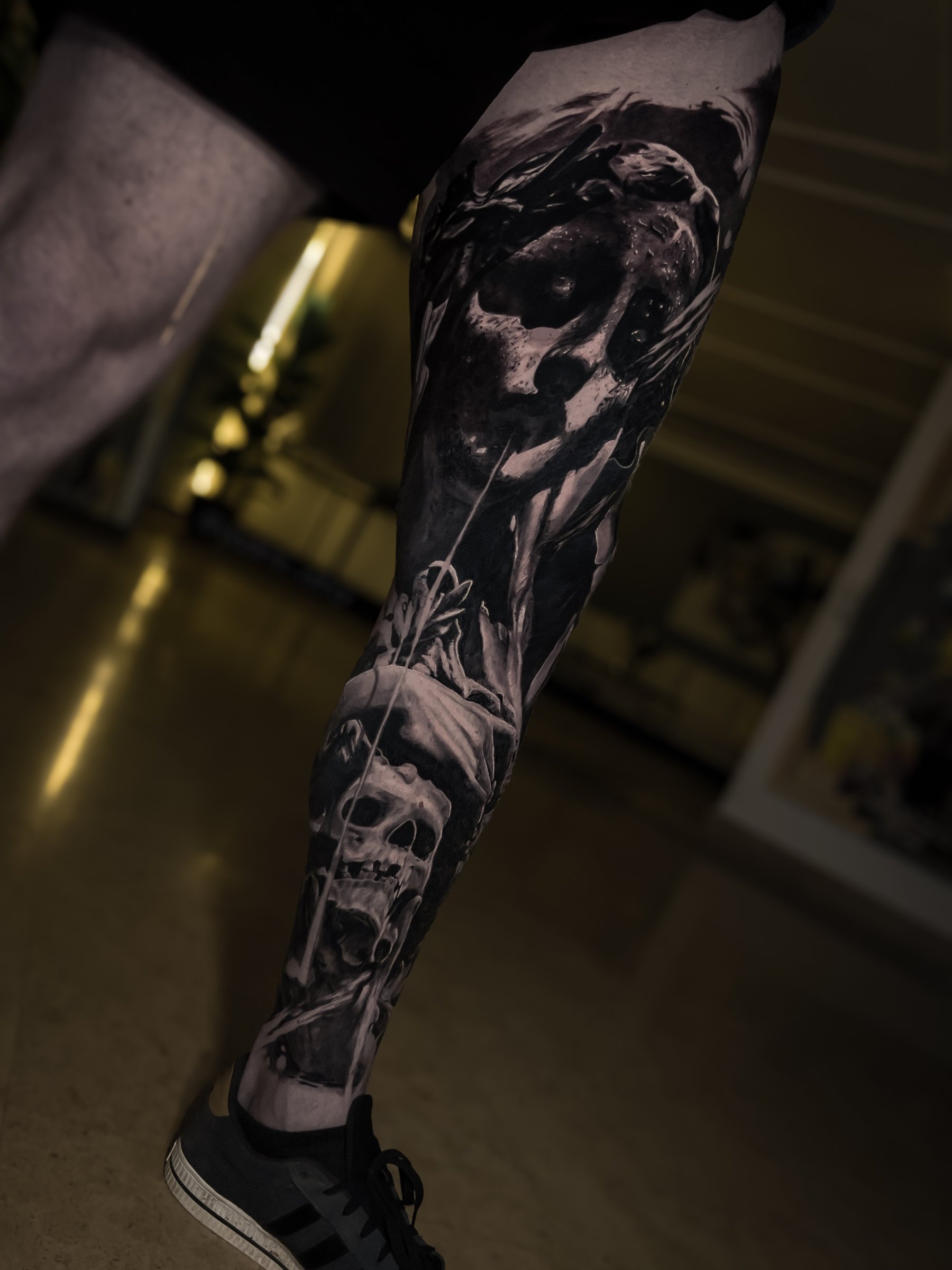 Second view of a large-scale black and grey realism leg tattoo by Vladimir Vishar