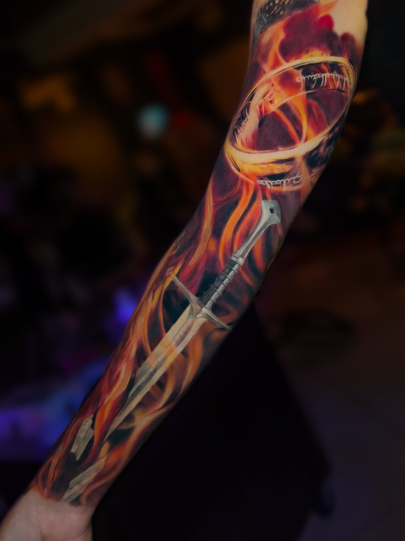 Large-scale colour realism arm tattoo with abstract linework by Vladimir Vishar