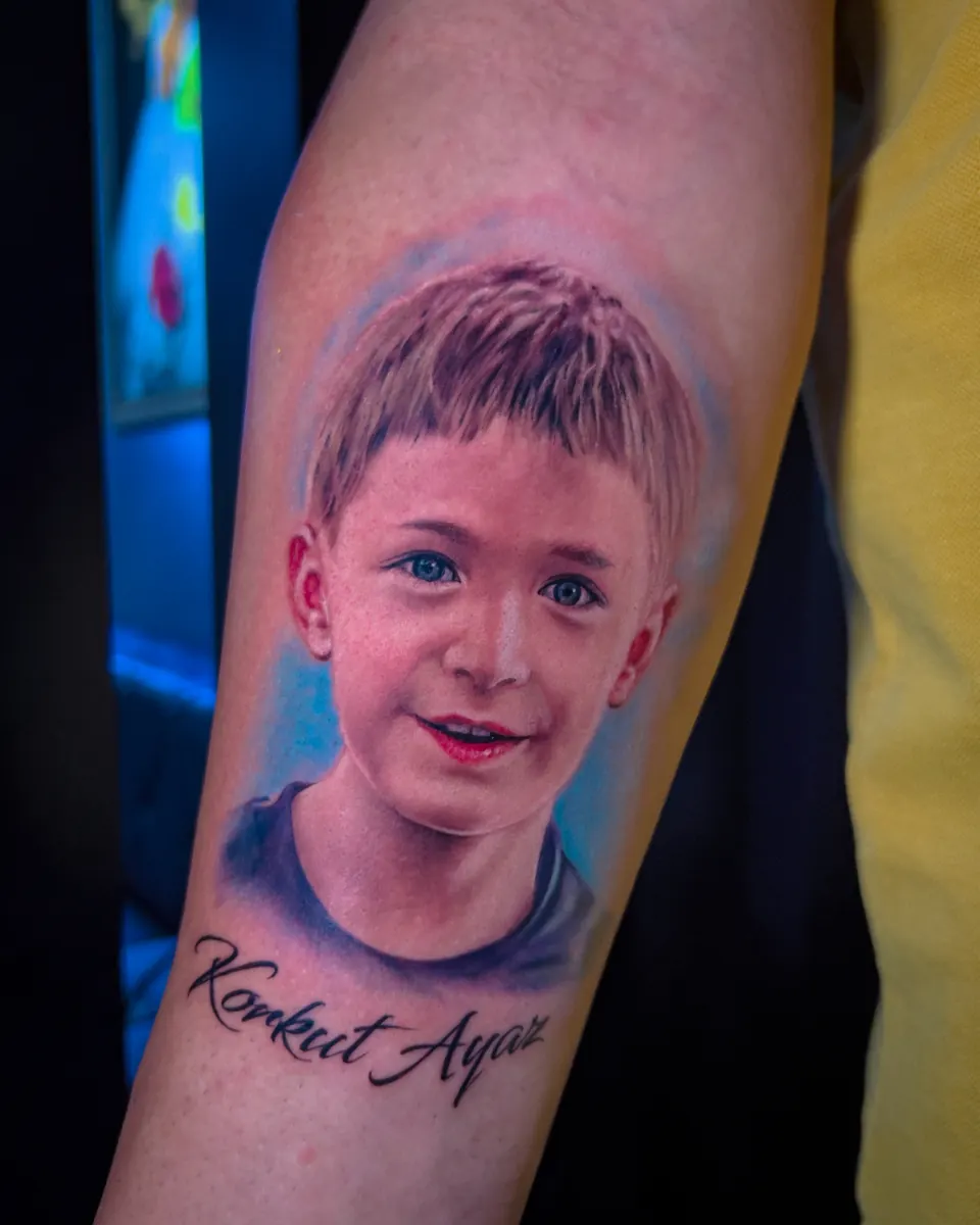 Colour realism child portrait tattoo with script by Vladimir Vishar