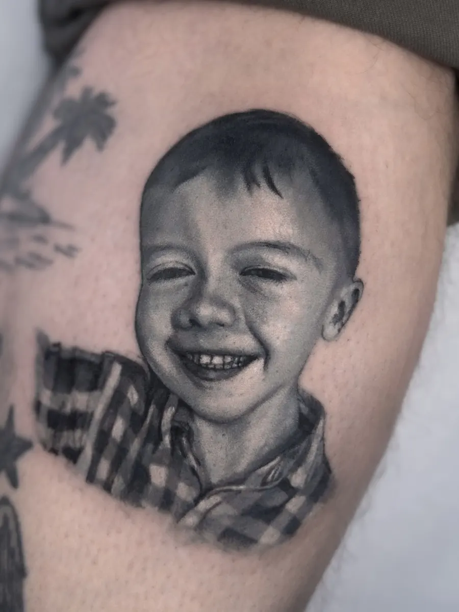 Black and grey child portrait tattoo by Vladimir Vishar